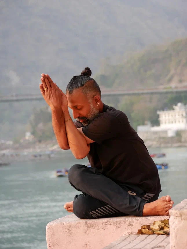 Seated practice on a platform beside the Ganga